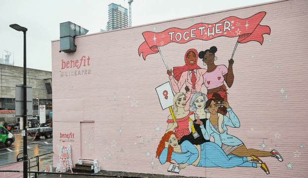 Mural with six women holding a banner that says 'together'